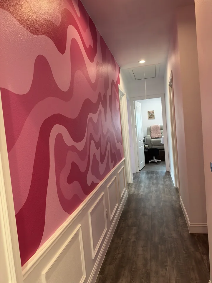 YA Studio hallway with pink wave walls leading to the pedicure room