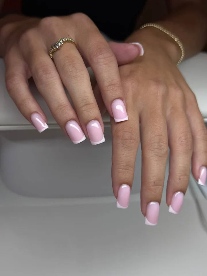 Pink gel manicure with clean white French tips